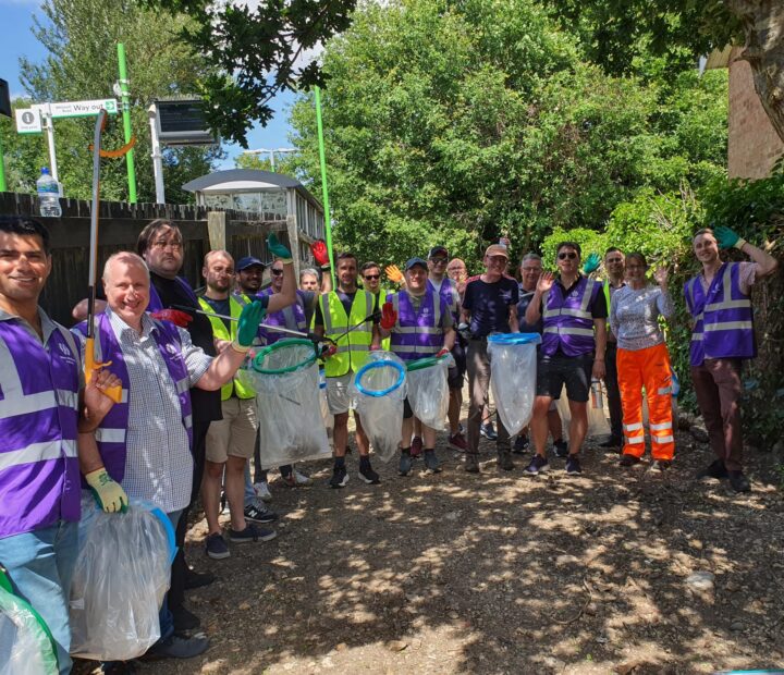 A group of volunteers litter picking at a community garden