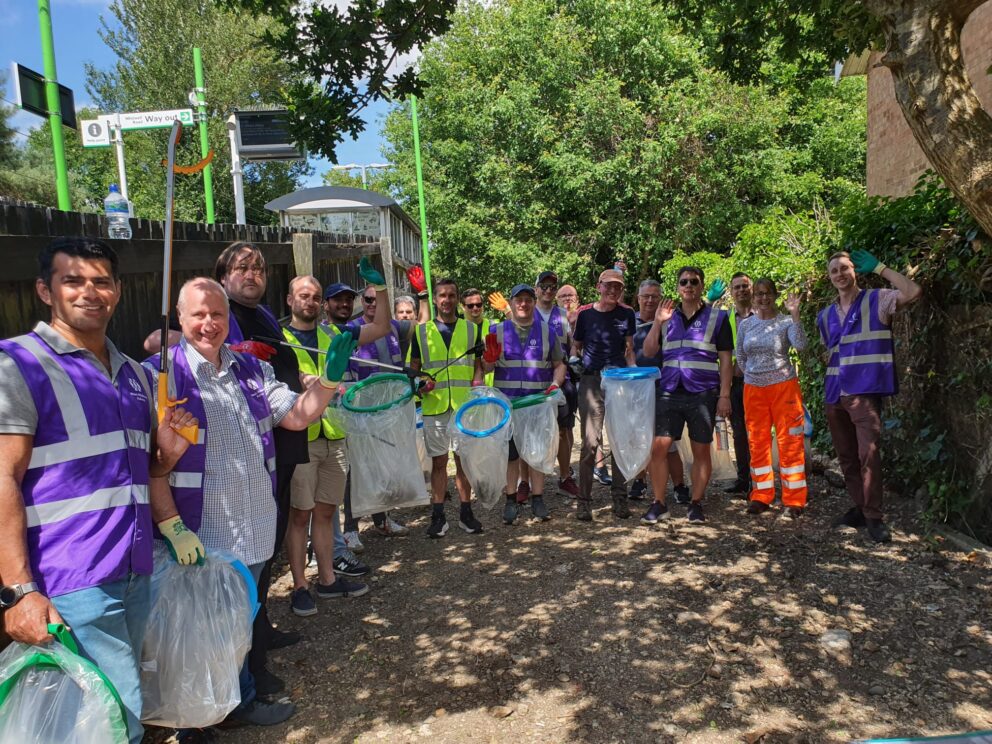 A group of volunteers litter picking at a community garden