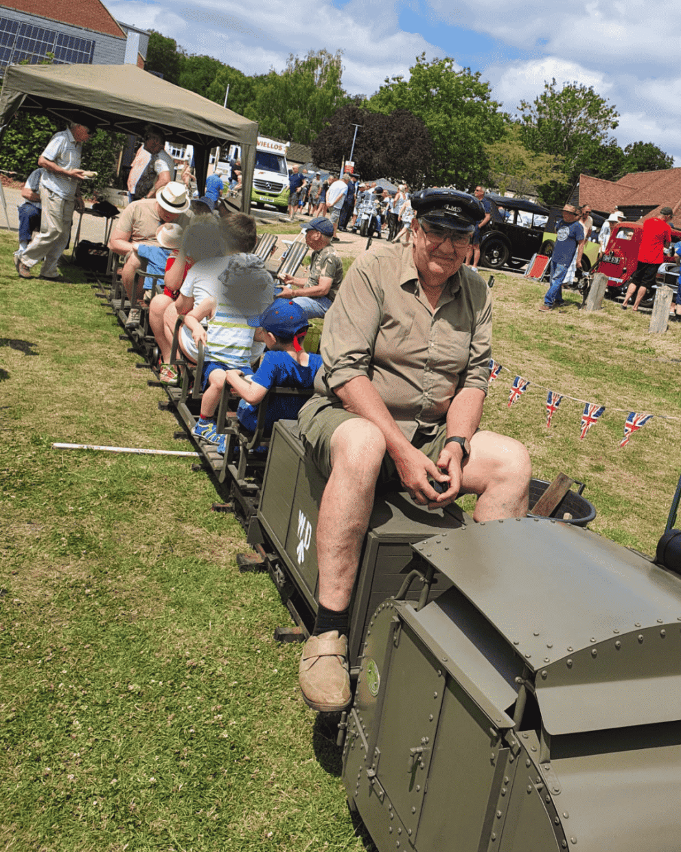 People on a mini-locomotive at a fair