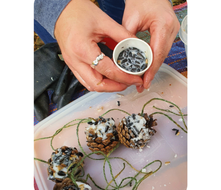 Volunteers making bird seed feeders