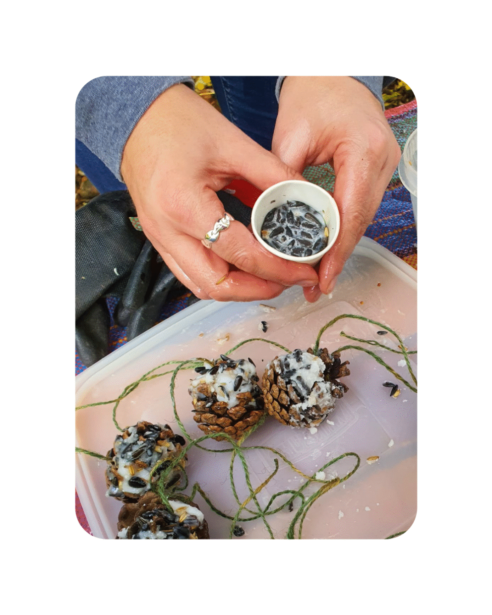 Volunteers making bird seed feeders