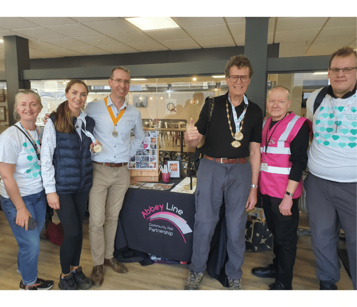 People by a community group stand