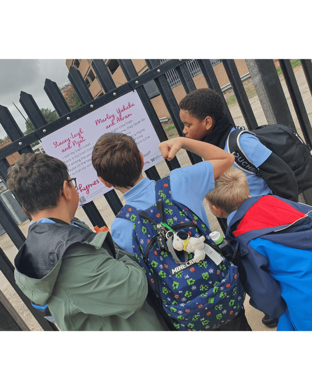 School children looking at creative work on a train platform