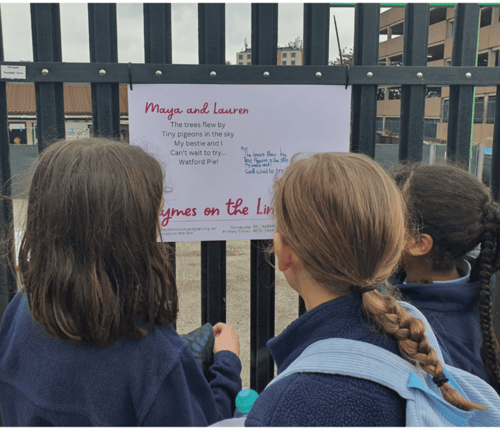 School children looking at creative work on a train platform