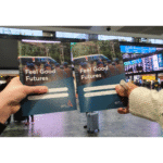 Students holding up activity books Feel Good Futures