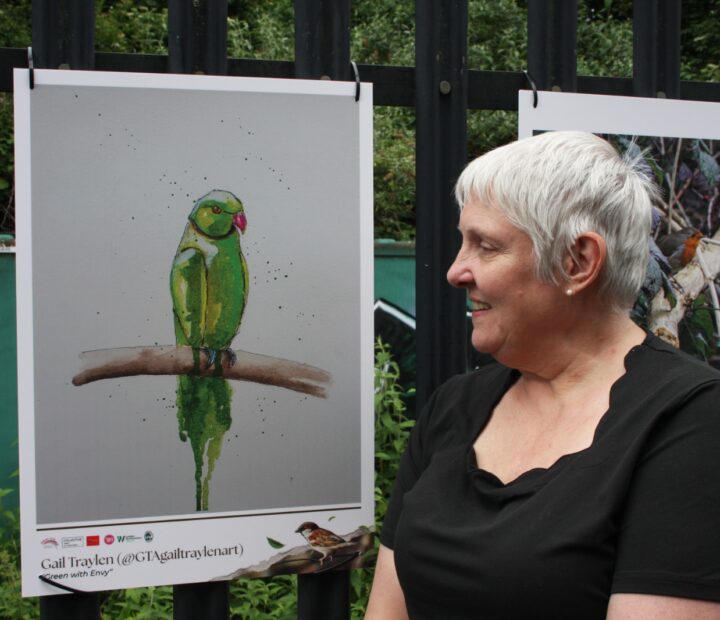 People admiring a community art exhibition at a railway station