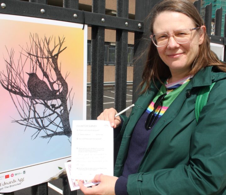 People admiring a community art exhibition at a railway station
