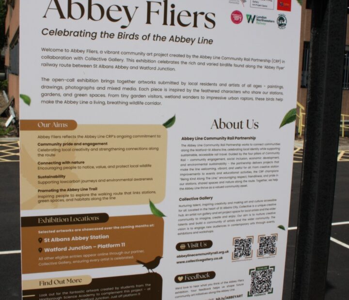 Information board about a community art exhibition at a railway station