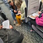 People filling in a survey on a train