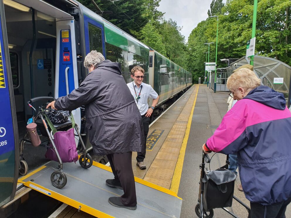 People with mobility issues boarding a train