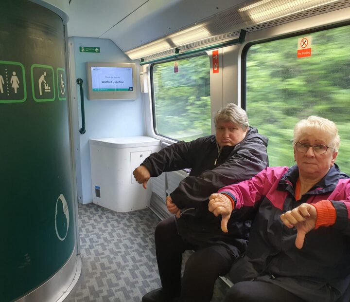 Two people looking sad on a train