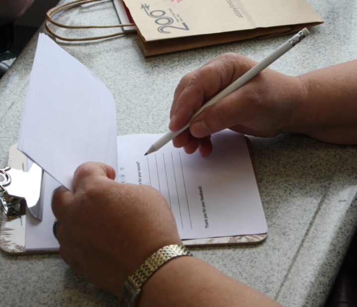 A person filling in a survey on a train