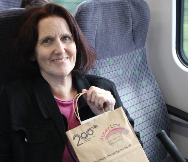 A person smiling on a train