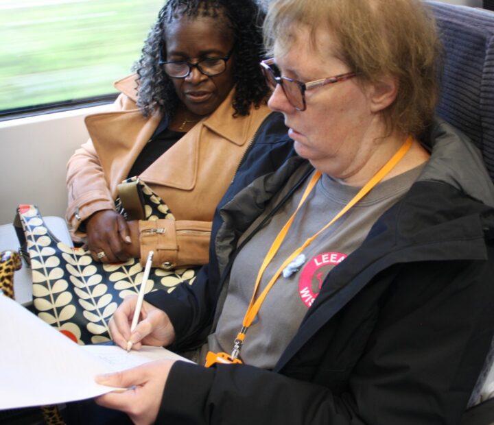A person filling out a survey on a triain