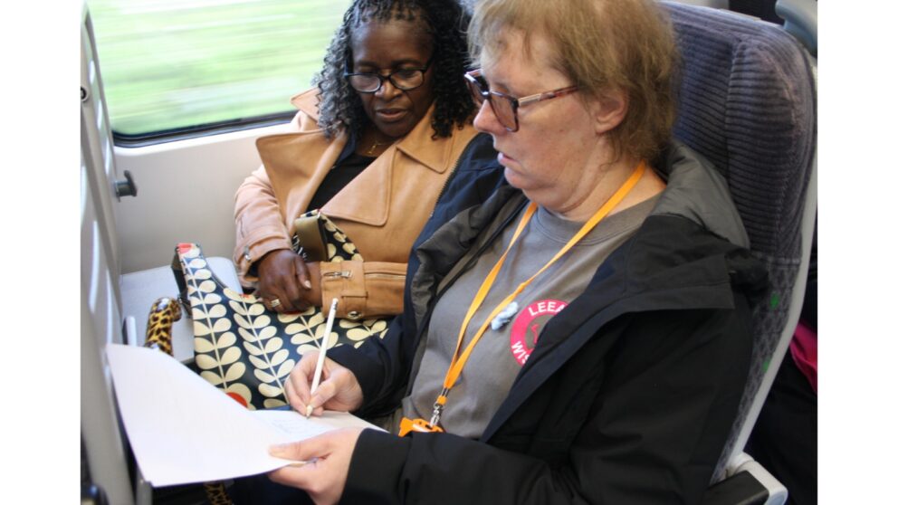 A person filling out a survey on a triain