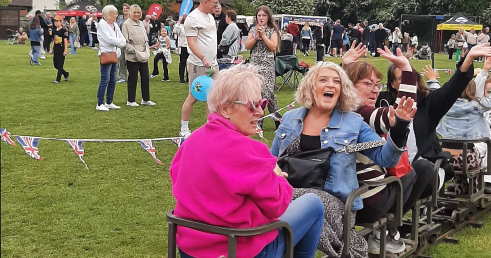 People laughing on a mini-train