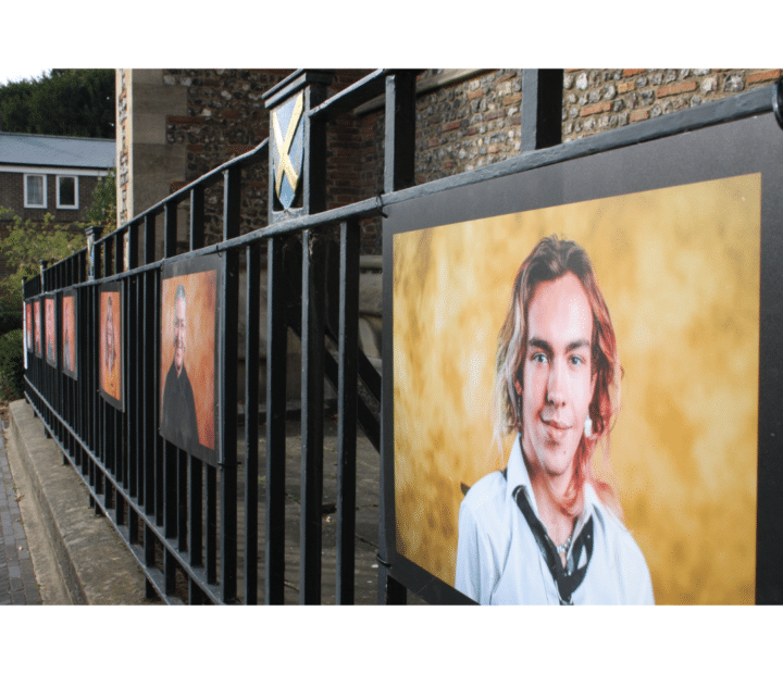 An outdoor portrait exhibition on railings